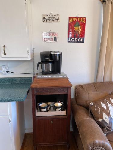 a kitchen with a coffee maker on a table next to a couch at Mountain View Guest Motel in Mountain View