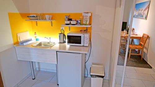 a small kitchen with a sink and a microwave at Vila Edith Valtice in Valtice