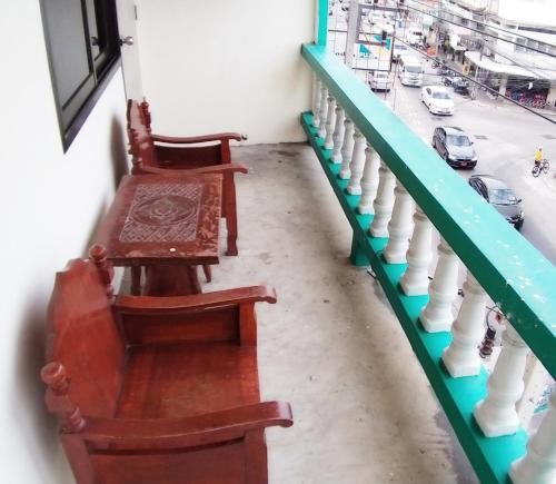 two chairs sitting on a balcony next to a street at รสริน ซีวิว in Pattaya North