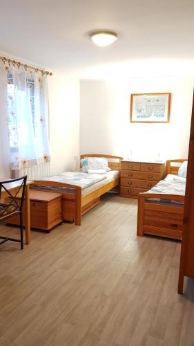 a bedroom with two beds and a table in it at Dům V Podzámčí in Mělník