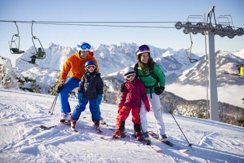 a group of people on skis on a ski lift at Kaiserwinkl Apartments Daxer in Walchsee