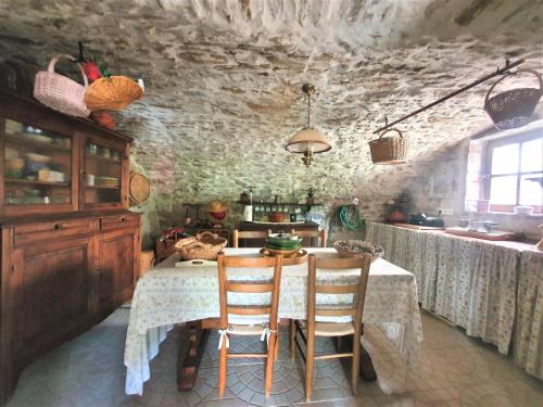 a kitchen with a table and chairs in a room at Mes Maisons Gardoises, Two Gites sleeping 13 with Two Private pools, Kids Room, Laundry, Disco, free WiFi, Linen and Dog's are Welcome in Gagnières
