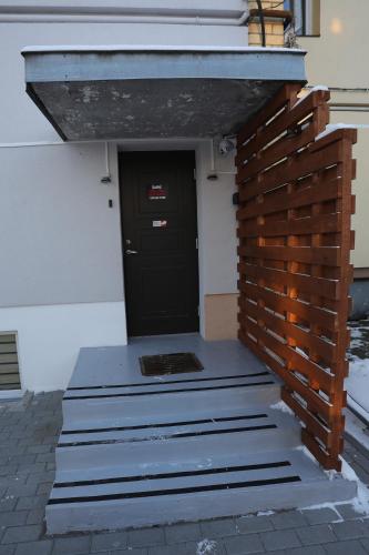 a entrance to a building with a black door at River Park apartments Ukmerge in Ukmergė