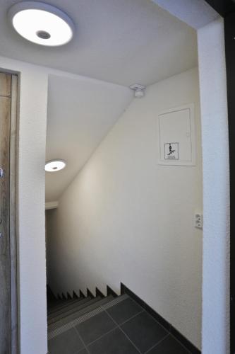 a hallway with white walls and a staircase at River Park apartments Ukmerge in Ukmergė