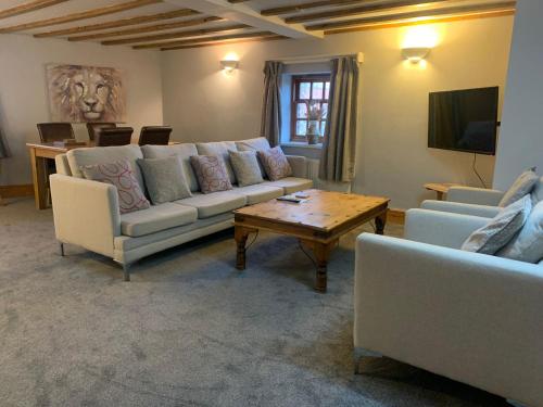 a living room with two couches and a coffee table at Apartment Two, The Carriage House, Bilbrough, York in York