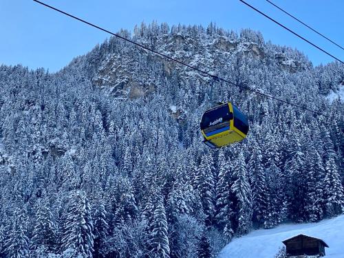 a ski lift in the middle of a snow covered mountain at HORBERG Appartements in Schwendau
