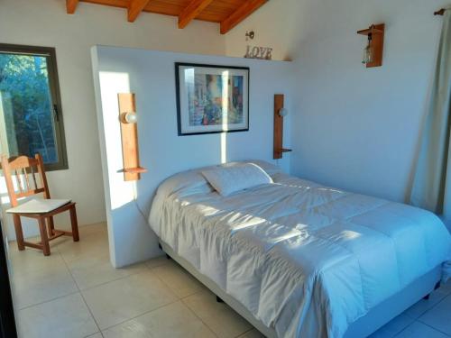 En eller flere senge i et værelse på Cabaña La Joaquina - Villa Giardino