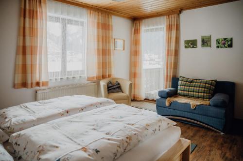 een slaapkamer met een bed, een stoel en een raam bij Ferienwohnung Inge Gapp in Gosau