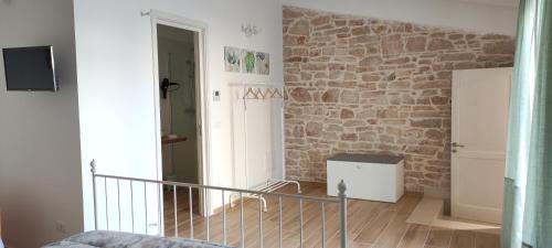 a room with a stone wall and a staircase at Appartamenti Mascagni in Sannicandro di Bari