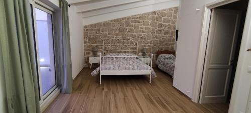 a bedroom with a bed and a stone wall at Appartamenti Mascagni in Sannicandro di Bari