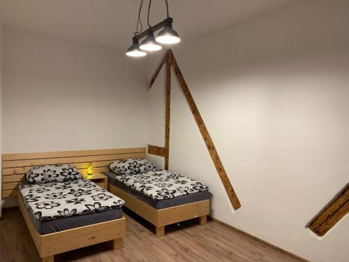 a room with two twin beds and a lamp at Apartmán na náměstí in Králíky