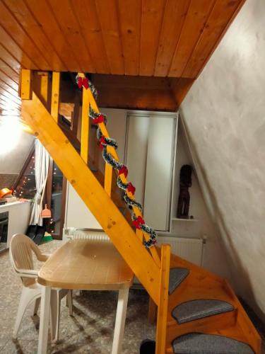 a wooden staircase in a room with a table at Popasul Dacilor in Predeluţ