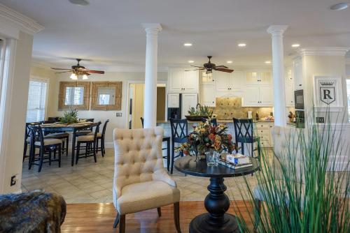 a kitchen and living room with a table and chairs at New - Spectacular️ Golf Views - Sleeps 20 - Pinehurst National #9 - Near DT Pinehurst! in Pinehurst