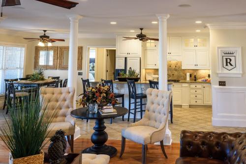 a kitchen and living room with a table and chairs at New - Spectacular️ Golf Views - Sleeps 20 - Pinehurst National #9 - Near DT Pinehurst! in Pinehurst