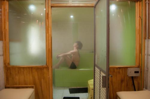 a woman sitting in a bath tub in a bathroom at Cabaña & Spa Sentido Vital in La Unión