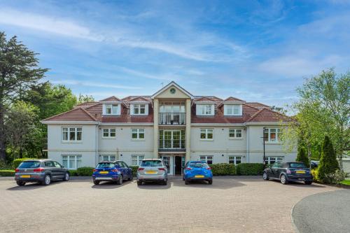 a large building with cars parked in front of it at Turnberry accommodation in Turnberry