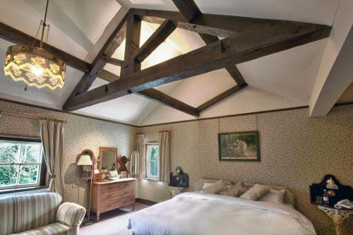 a bedroom with a bed and a table and a couch at Hodgkinsons Hotel Matlock Bath in Matlock