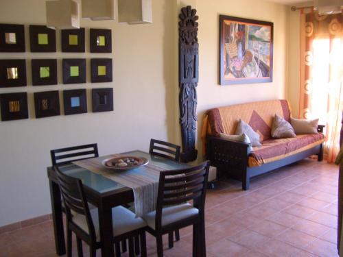 a living room with a table and a couch at Atico Mirador al Mar in Alcossebre