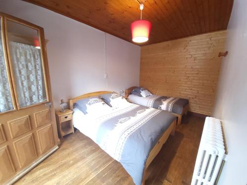 a bedroom with a bed in a room with a window at La Ferme De Fernand in Sixt