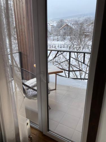 a sliding glass door with a view of a balcony at Girske Povitria 2 in Yaremche
