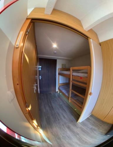 een ronde hal met een kamer met stapelbedden bij Location appartement Chamrousse 1650 - Superbe vue in Chamrousse