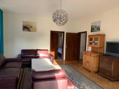 a living room with a couch and a tv at Landgasthaus Klosterhof in Fischbach