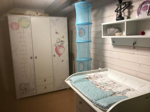 a childs room with a crib and a bed at Der Schmidthof in Todtmoos