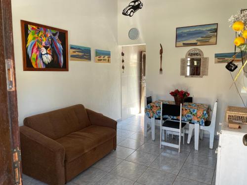 a living room with a couch and a table at Vila Colorida casa 2 in Fazendinha