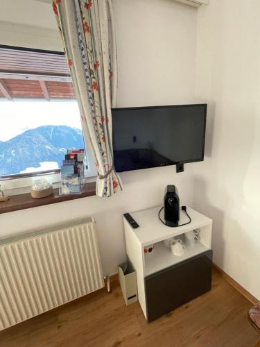 a living room with a flat screen tv on the wall at Koflers Ferienwohnungen in Oberperfuss