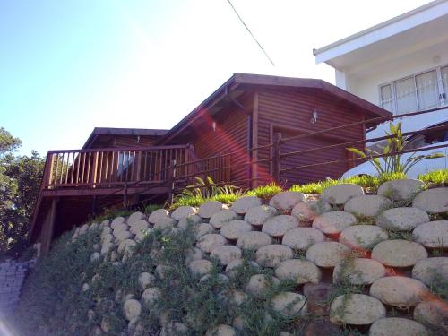 a stone retaining wall in front of a house at Shad in Palm Beach