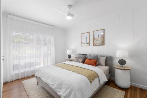 a white bedroom with a large bed and a window at Foxmount Estate - MAGNUS in Mount Gambier
