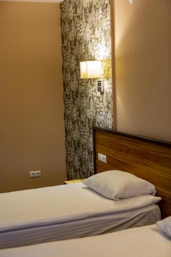 a bedroom with a bed with a headboard and a mirror at Hotel Shengen "Шенген" in Kropyvnytskyi