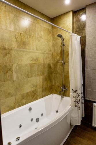 a white bath tub in a bathroom with a shower at Hotel Shengen "Шенген" in Kropyvnytskyi