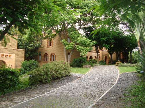 a cobblestone path in front of a building at Mision del Sol Resort & Spa Adults Only in Cuernavaca