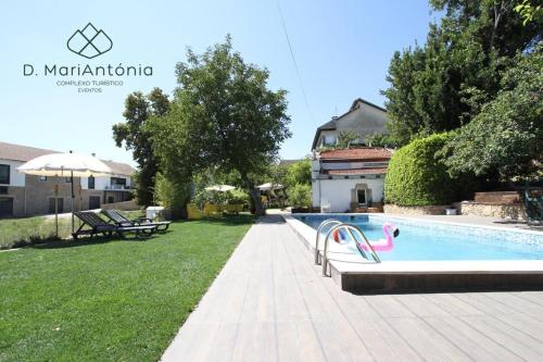 a swimming pool in the backyard of a house at D. MariAntónia Complexo Turístico in Bragança