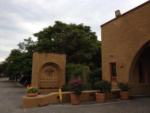 a building with pots of flowers in front of it at Mision del Sol Resort & Spa Adults Only in Cuernavaca