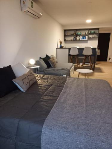 a living room with a large bed and a couch at Estudio Loft in Mar del Plata