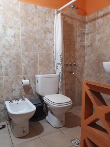 a bathroom with a toilet and a sink at Pillanhuasi alquiler por dia in Villa Unión