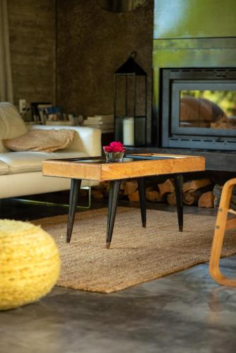 a coffee table in a living room with a fireplace at CASA LOBO - La Pedrera -Luxury- Diseño junto al Mar in La Pedrera