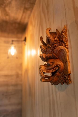 a wooden lion gargoyle on a wall at CASA LOBO - La Pedrera -Luxury- Diseño junto al Mar in La Pedrera