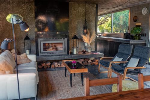 a living room with a couch and a fireplace at CASA LOBO - La Pedrera -Luxury- Diseño junto al Mar in La Pedrera