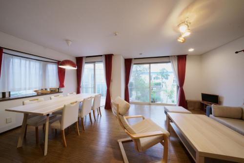 a living room with a long table and chairs at Atagohama seaside House in Fukuoka