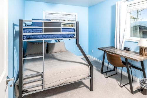 a bedroom with a bunk bed and a desk at Midtown Anchorage Basecamp Condo A in Anchorage