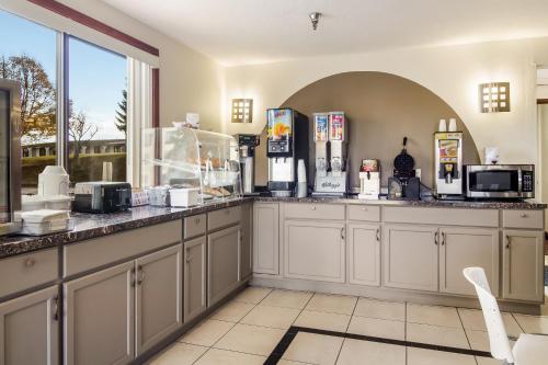 a kitchen with white cabinets and a counter at Days Inn by Wyndham Somerset PA I-70 I-76 in Somerset