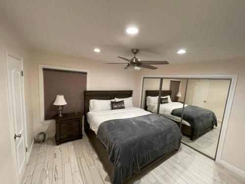 a bedroom with two beds and a ceiling fan at Cheerful, Beautifully Remodeled, Modern, Comfortable Home in Los Angeles