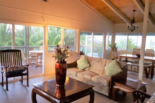 a living room with a couch and a table at Hawaiian Paradise in Keaau