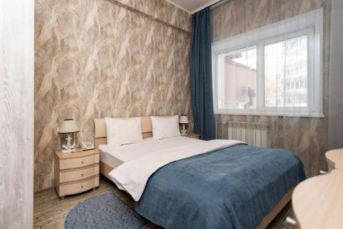 a bedroom with a bed and a window at Hotel 7 Dorog in Irkutsk