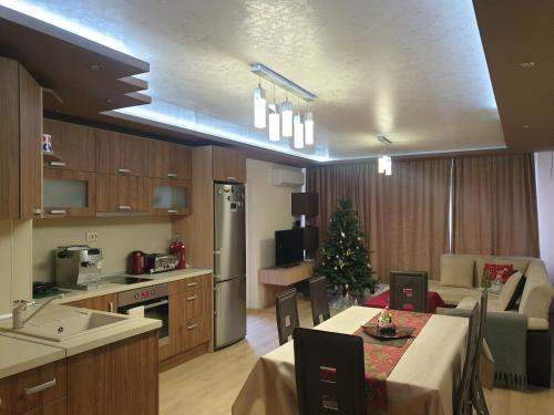 a kitchen and living room with a christmas tree in it at Luxury Two Bedroom Flat in Blagoevgrad