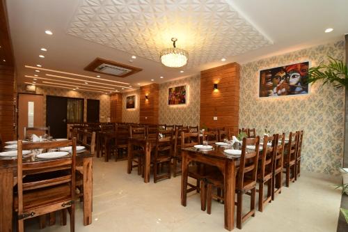 a dining room with wooden tables and chairs at Hotel Life Inn in Jaipur