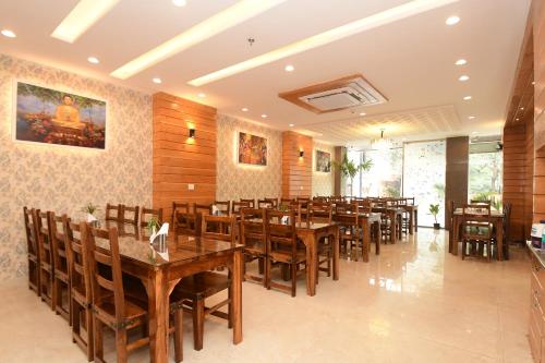 a dining room with wooden tables and chairs at Hotel Life Inn in Jaipur